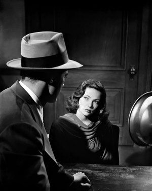 1944: Dana Andrews puts the spotlight on Gene Tierney during the interrogation scene of the film noir, 'Laura', directed by Otto Preminger.